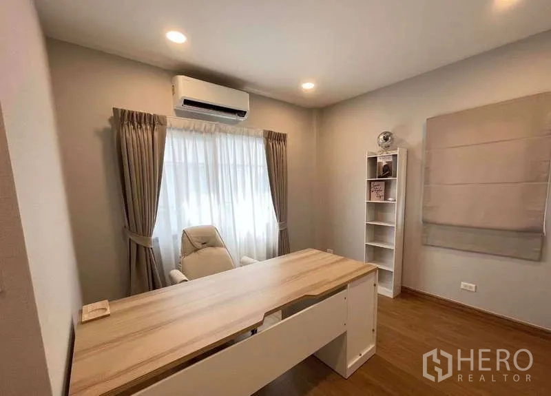 Detached House for rent in Bang Phli, Samut Prakan - Home office featuring a long wooden desk, task chair, shelving and curtained window