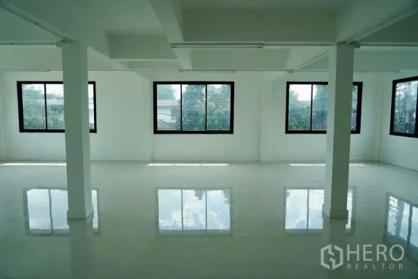 Office Space for sale in Khan Na Yao, Bangkok - Spacious office floor with wraparound windows and polished white tiles providing abundant natural light.