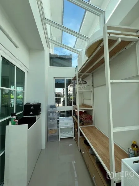 Detached House for rent or sale - Pantry or utility room with skylight roof and storage shelves.