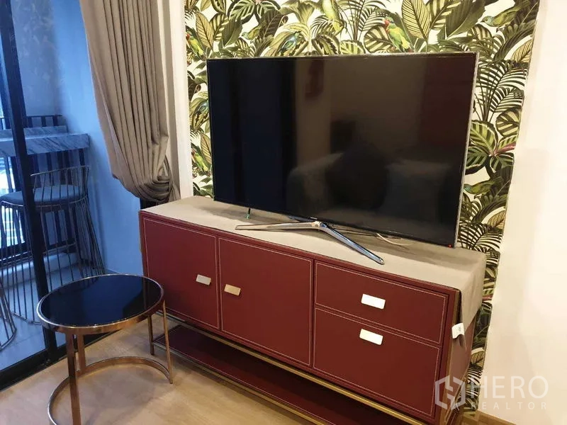 公寓 出租在Bang Rak, Bangkok - 大屏电视置于酒红色电视柜旁靠近阳台