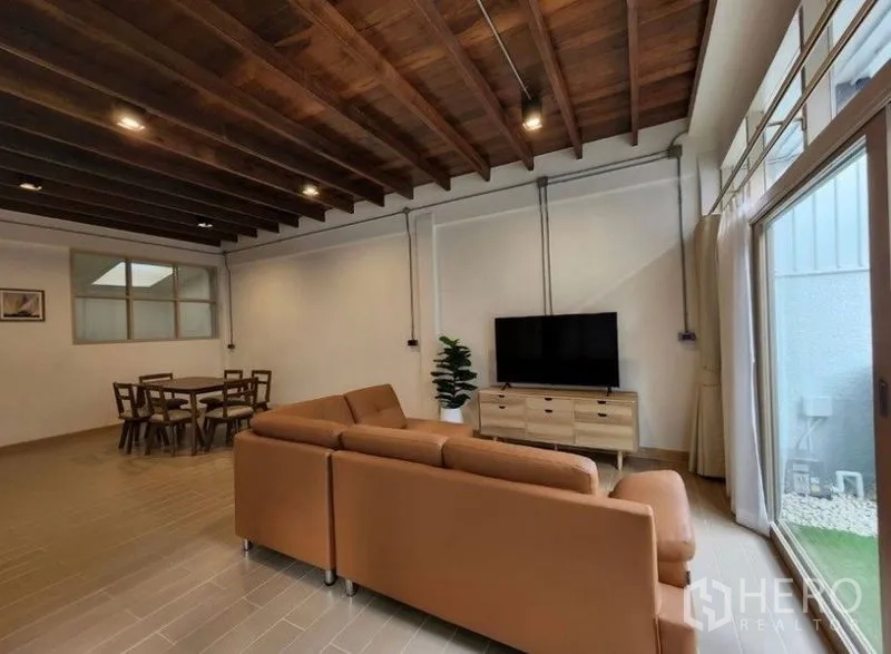 Townhouse for sale - Spacious living and dining area facing sliding doors to a small patio.