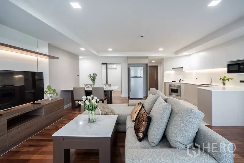 Apartment for rent - Open-plan lounge facing modern kitchen and dining setup.