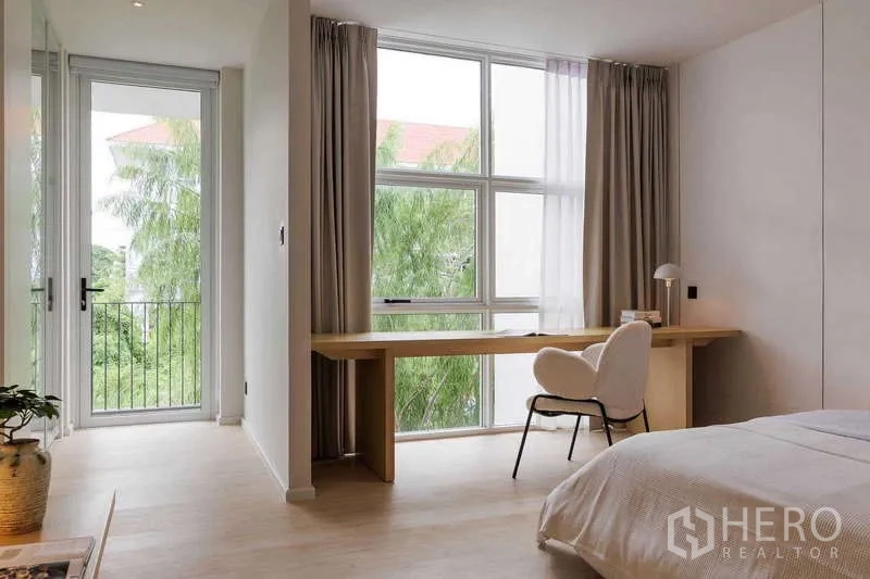 Home Office for rent in Bang Phli, Samut Prakan - Bedroom with large picture window, long built-in desk and small balcony view.