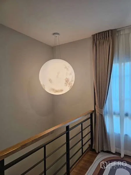 Detached House for rent in Bang Phli, Samut Prakan - Stairwell featuring a spherical pendant lamp beside a tall window with curtains.