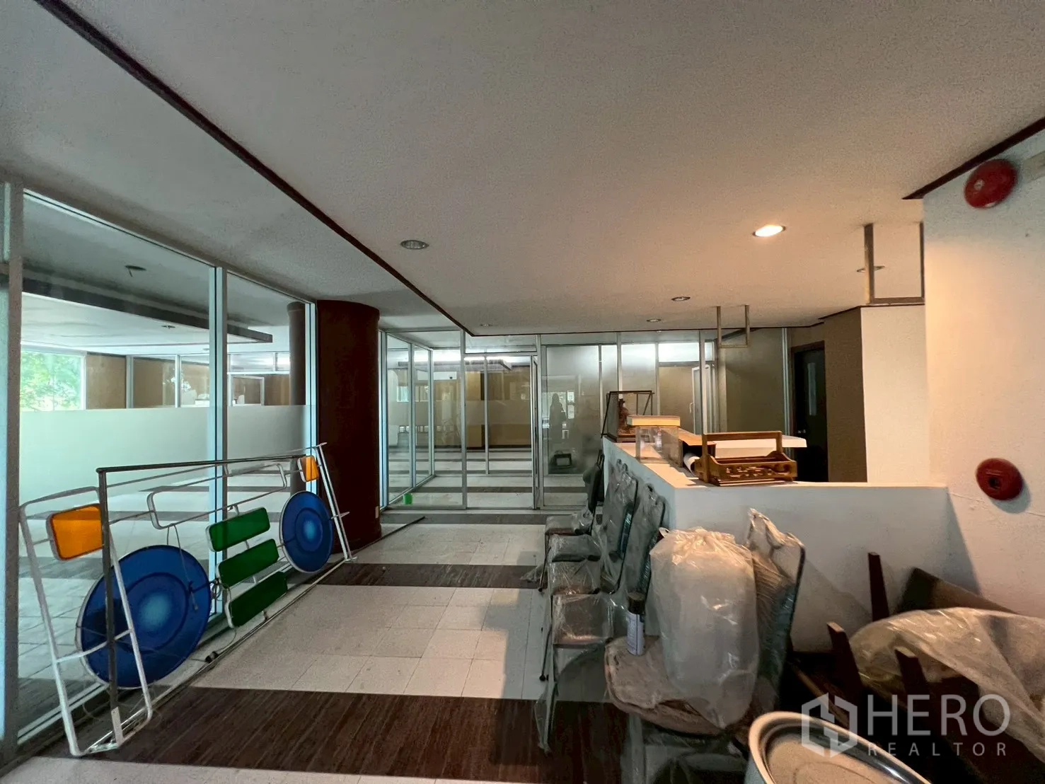 Retail Space for rent - Reception zone with built-in counter, seating and full-height glass partitions overlooking the retail floor.