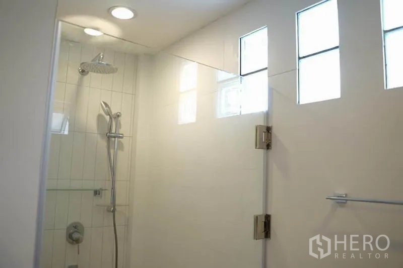 Detached House for rent in Wang Thonglang, Bangkok - Glass-enclosed shower with rain showerhead and high privacy windows.