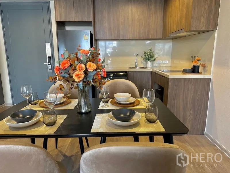 คอนโด ให้เช่าในPathum Wan, Bangkok - โต๊ะทานอาหารสำหรับสี่ที่นั่งข้างครัวบิวท์อินลายไม้พร้อมตู้แขวน