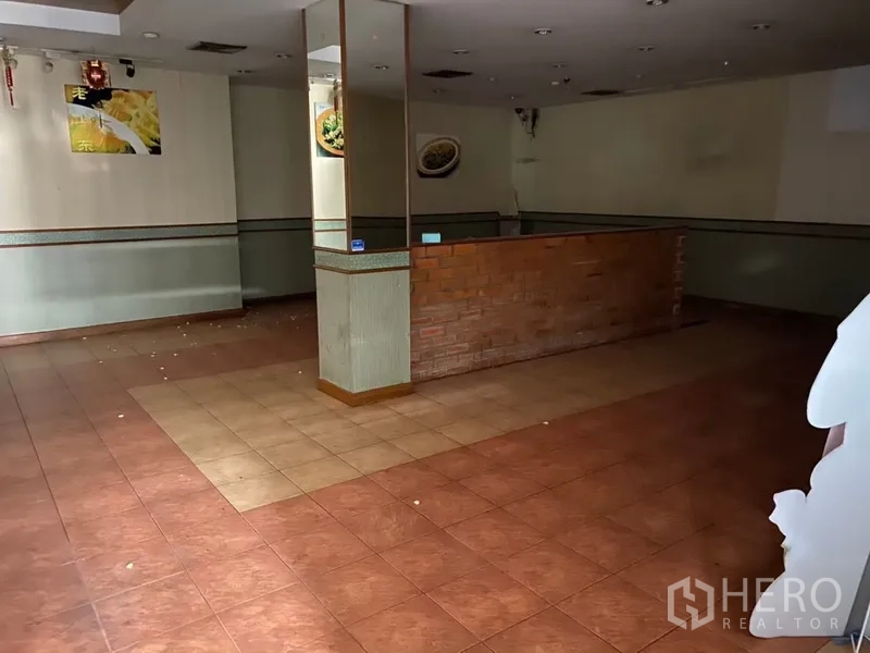 零售空间 出租 - 开放式零售区，中央立柱、砖砌服务台与拼色地砖，待装修