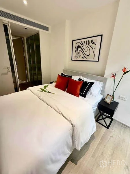 Condominium for rent - Bedroom from another angle showing wardrobe doors and bedside tables.