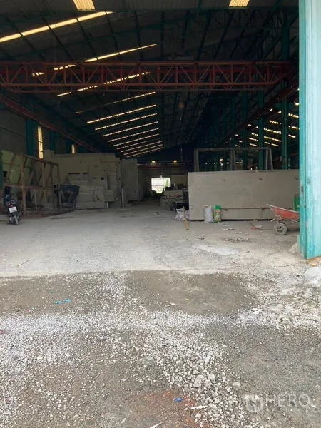 คลังสินค้า ให้เช่าในMueang Samut Sakhon, Samut Sakhon - โถงโกดังลึก มีโครงค้ำสีแดงด้านบน และวัสดุอุปกรณ์จัดวางภายใน