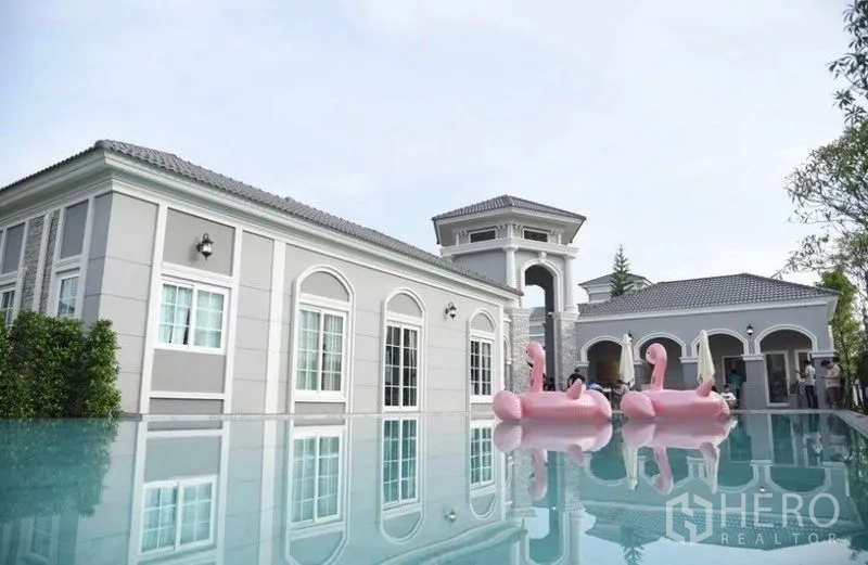 Detached House for rent or sale - Community clubhouse with European-style architecture overlooking an outdoor swimming pool.