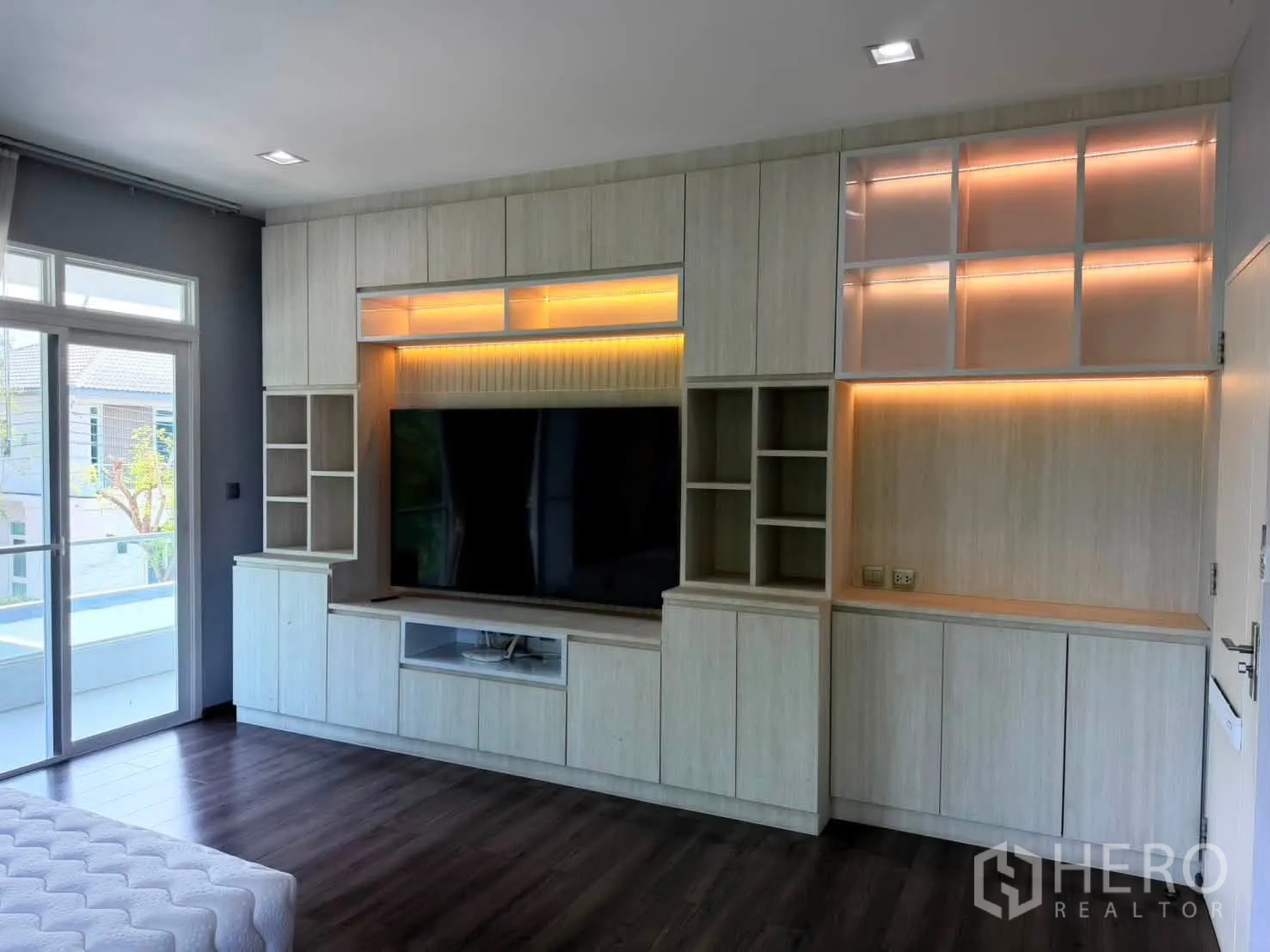 Detached House for rent in Bang Phli, Samut Prakan - Close-up of custom lighted cabinetry with mounted TV and storage.