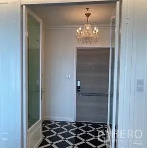 Condominium for rent or sale - Entry foyer with chandelier lighting, digital door lock, and black-and-white checkered floor tiles.
