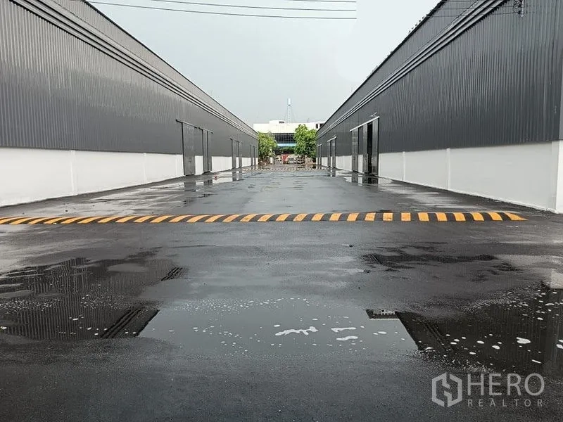 货栈 出租在Khlong Toei, Bangkok - 园区中央通道，雨后路面映射与减速带