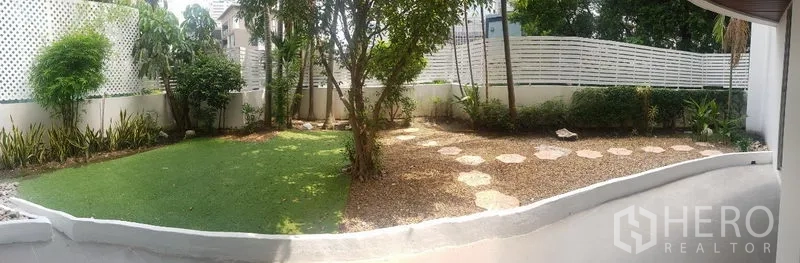 Apartment for rent in Khlong Toei, Bangkok - Landscaped garden courtyard with lawn, trees and stepping-stone path