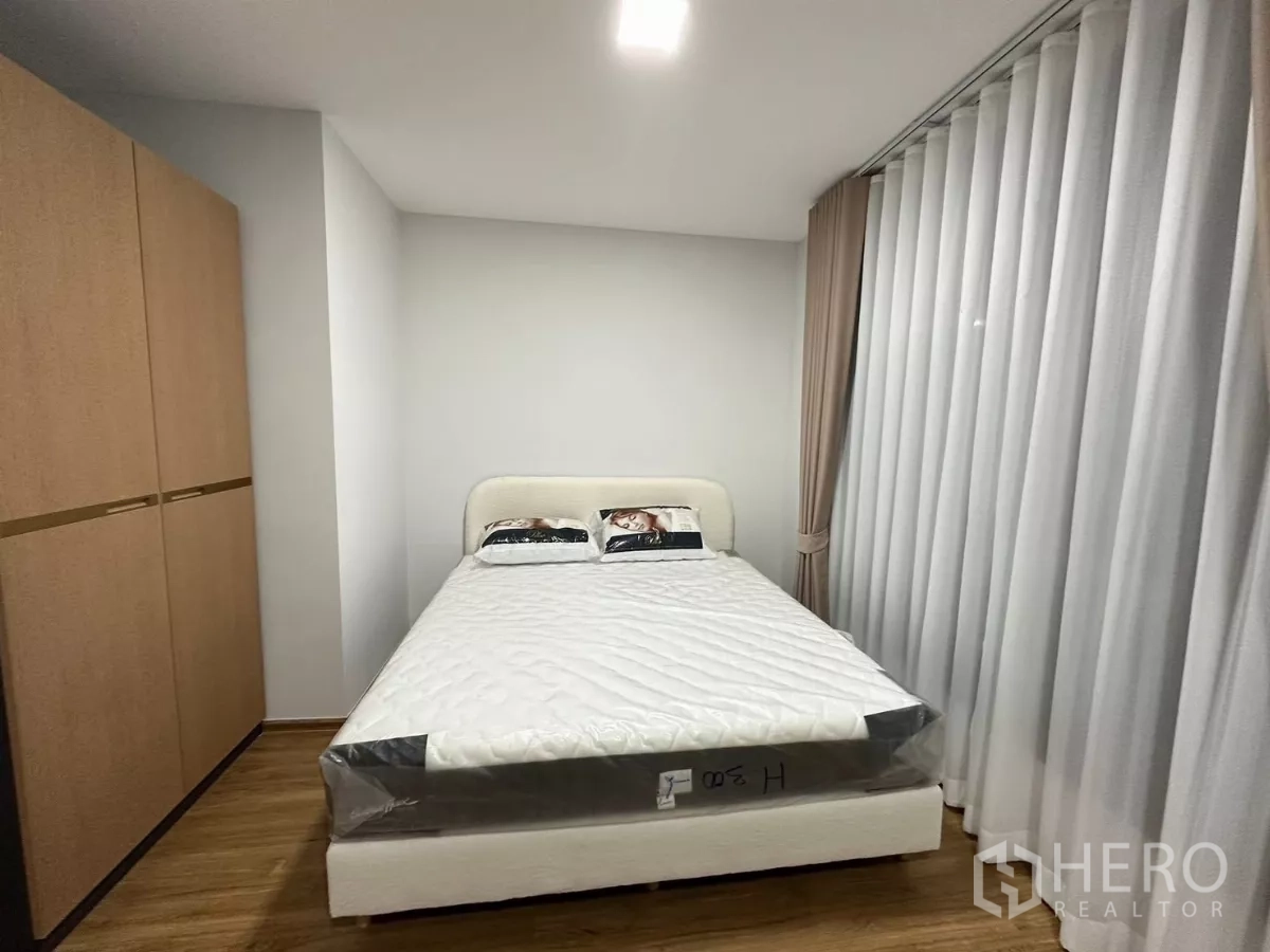 ทาวน์เฮาส์ ให้เช่าในBang Phli, Samut Prakan - ห้องนอนหลักพร้อมเตียงคู่ ตู้เสื้อผ้า และผ้าม่านเต็มความสูง