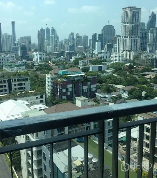 Condominium for rent in Khlong Toei, Bangkok - Balcony railing with daytime view of the Sukhumvit high-rise skyline.