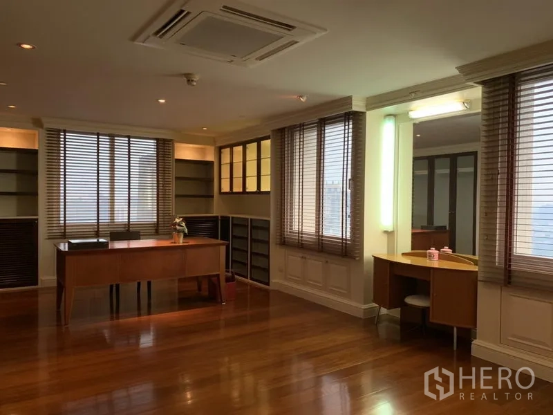 Condominium for rent or sale in Watthana, Bangkok - Bright study with built-in shelving, two desks and city views through blinds.