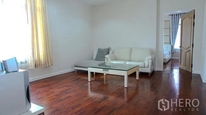 Detached House for rent in Bang Phli, Samut Prakan - Front exterior of a two-storey detached house with gated entry, covered carport and palm tree.