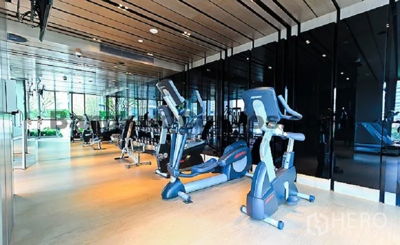 公寓 出租在Watthana, Bangkok - 健身房配有有氧器械、自由重量区、镜面墙与木地板。