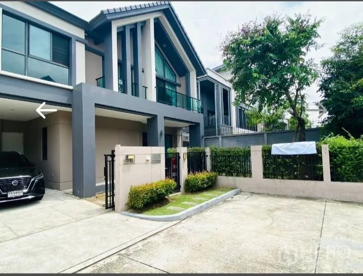 Detached House for sale in Saphan Sung, Bangkok - Modern detached house exterior with carport, driveway and small front garden.