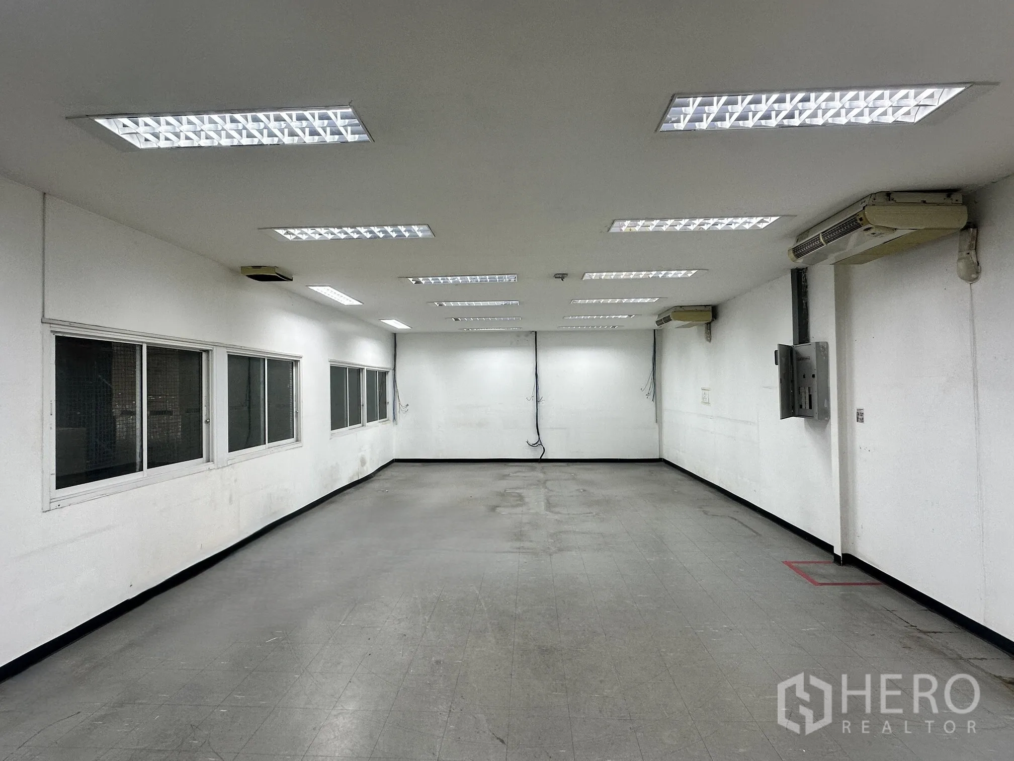 Warehouse for rent in Lat Krabang, Bangkok - Large internal office space with windows and multiple air-conditioning units.
