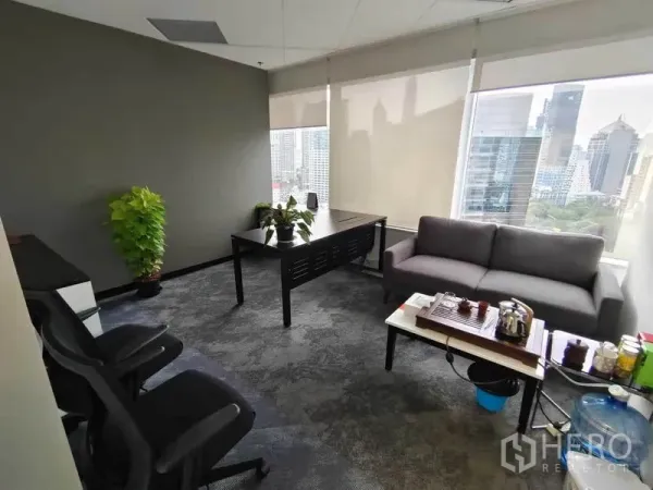 Office Space for rent in Pathum Wan, Bangkok - Executive corner office with desk, sofa seating and skyline views through large windows.