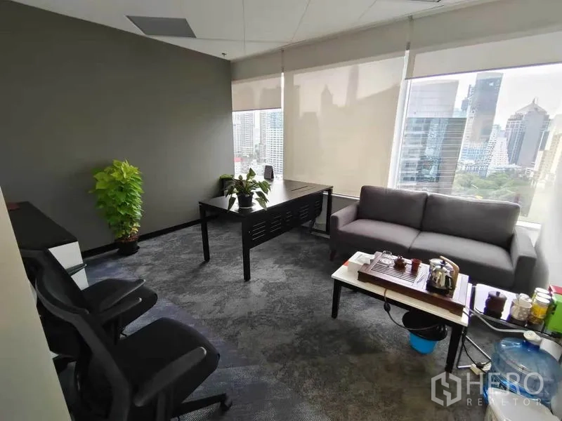Office Space for rent in Pathum Wan, Bangkok - Executive corner office with desk, sofa seating and skyline views through large windows.