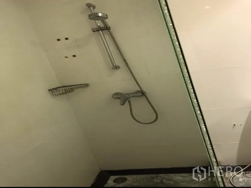 Condominium for rent or sale in Watthana, Bangkok - Enclosed shower area with handheld shower and glass partition.