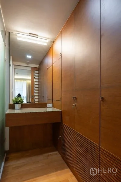 公寓 出售 - 步入式衣帽间，整面木柜与梳妆台。