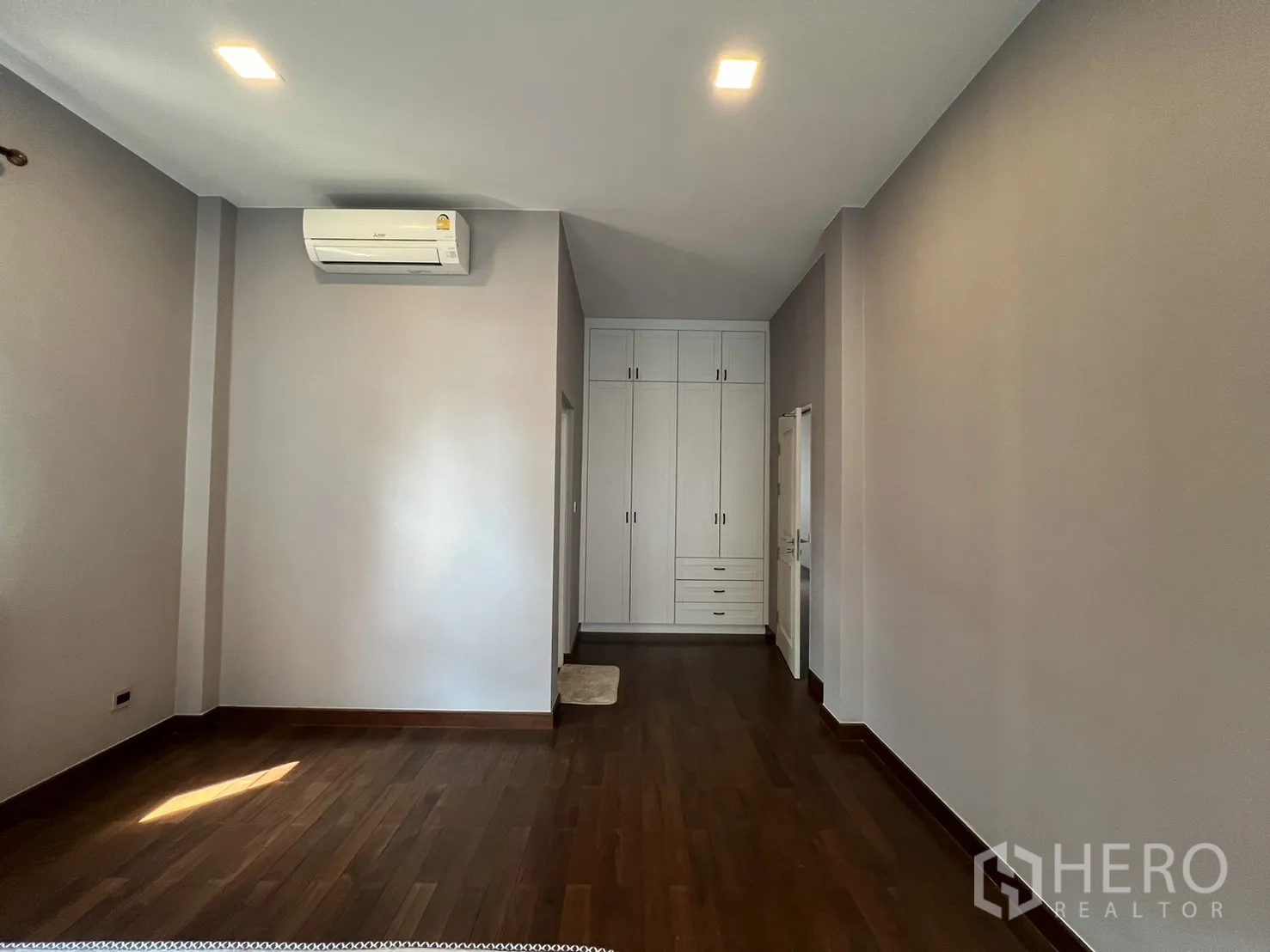 Detached House for rent or sale in Prawet, Bangkok - Compact tiled room with window and wall air-conditioner.
