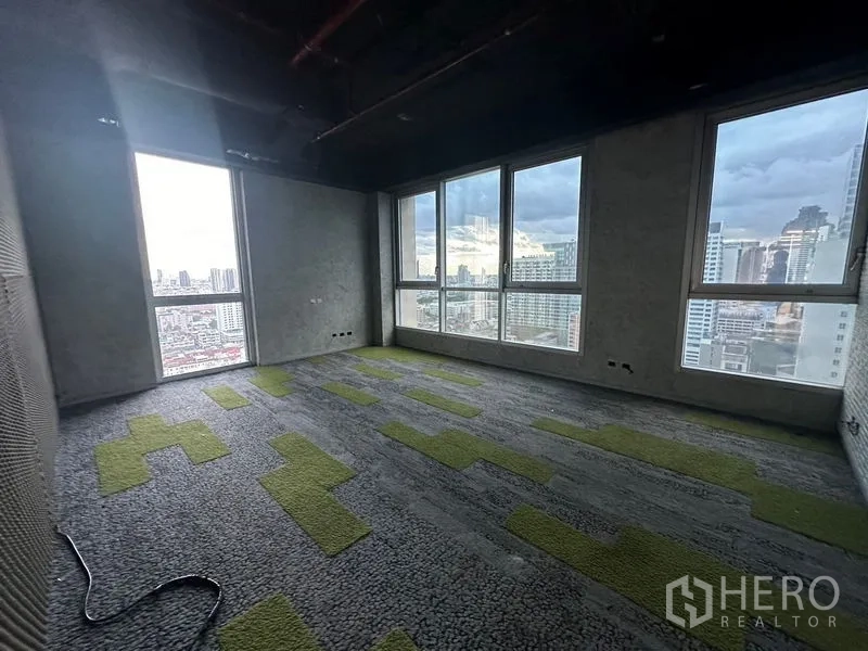 Office Space for rent in Bang Rak, Bangkok - Carpeted meeting room with green accents and panoramic city views.