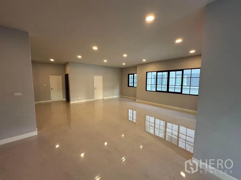 Detached House for rent or sale in Bang Phli, Samut Prakan - Large open-plan room with recessed ceiling lights and wide windows for flexible layouts.