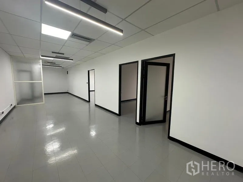 Office Space for rent - Office corridor with LED strip lighting and several private rooms along the wall.