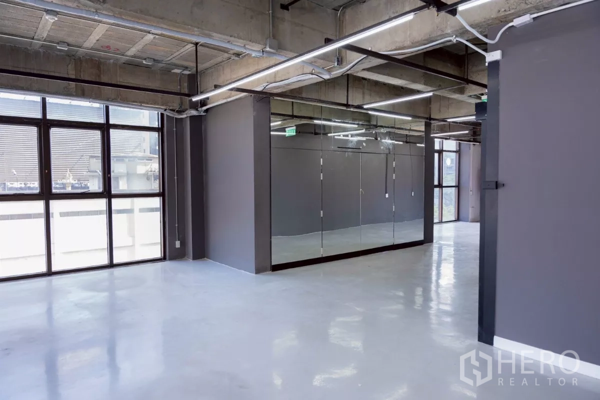 Office Space for rent - Studio or meeting zone with full mirrored wall panels and abundant natural light.