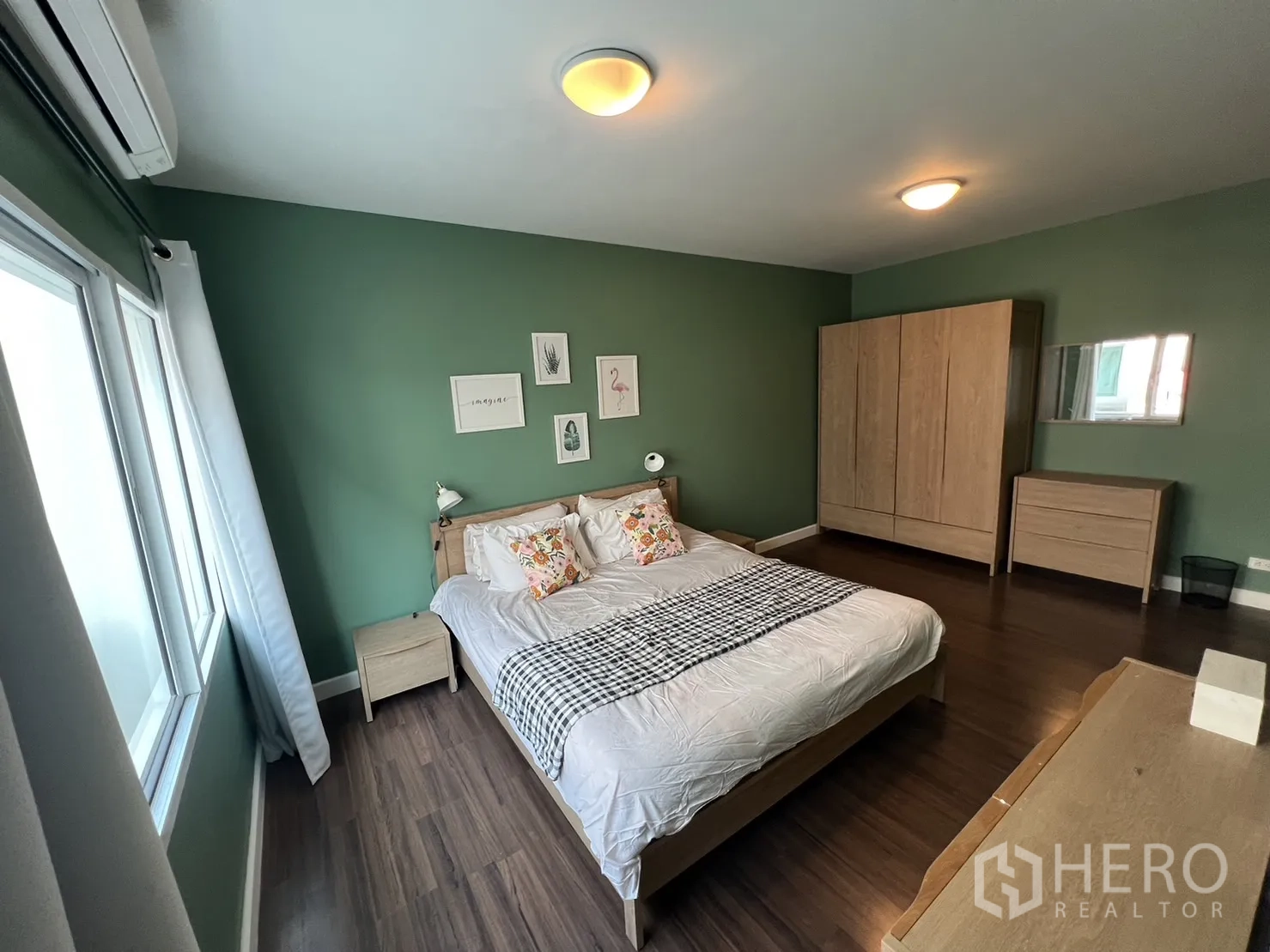 ทาวน์เฮาส์ for rent in Suan Luang, Bangkok - ห้องนอนผนังสีเขียวพร้อมตู้และโต๊ะหัวเตียง.