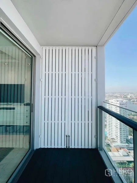 Condominium for rent or sale in Bang Kho Laem, Bangkok - Covered balcony with glass railing and white louver screen overlooking the city.