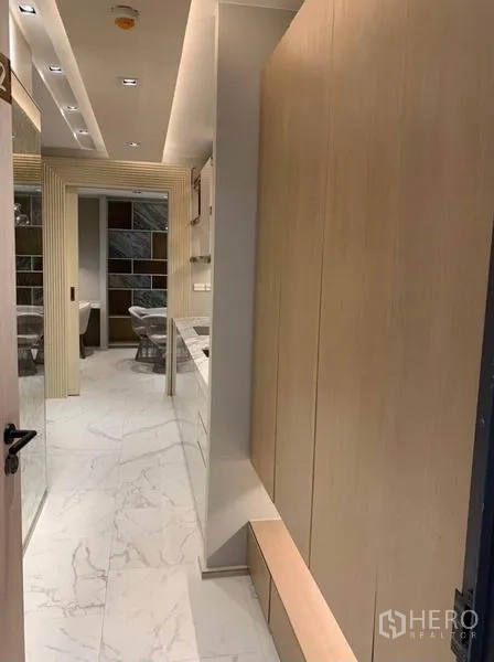คอนโด ให้เช่าในWatthana, Bangkok - โถงทางเดินสว่าง ปูพื้นลายหินอ่อน ตู้ไม้สีอ่อน เชื่อมสู่ครัว