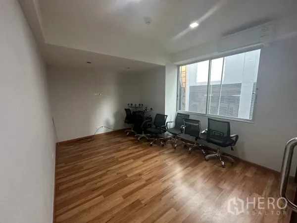 办公空间 出租在Khlong Toei, Bangkok - 采光明亮的办公室，大窗户、木地板、一排座椅与壁挂空调