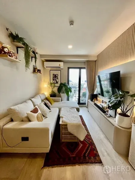 Condominium for sale - Cozy living room with sectional sofa, rug and balcony outlook across the city.