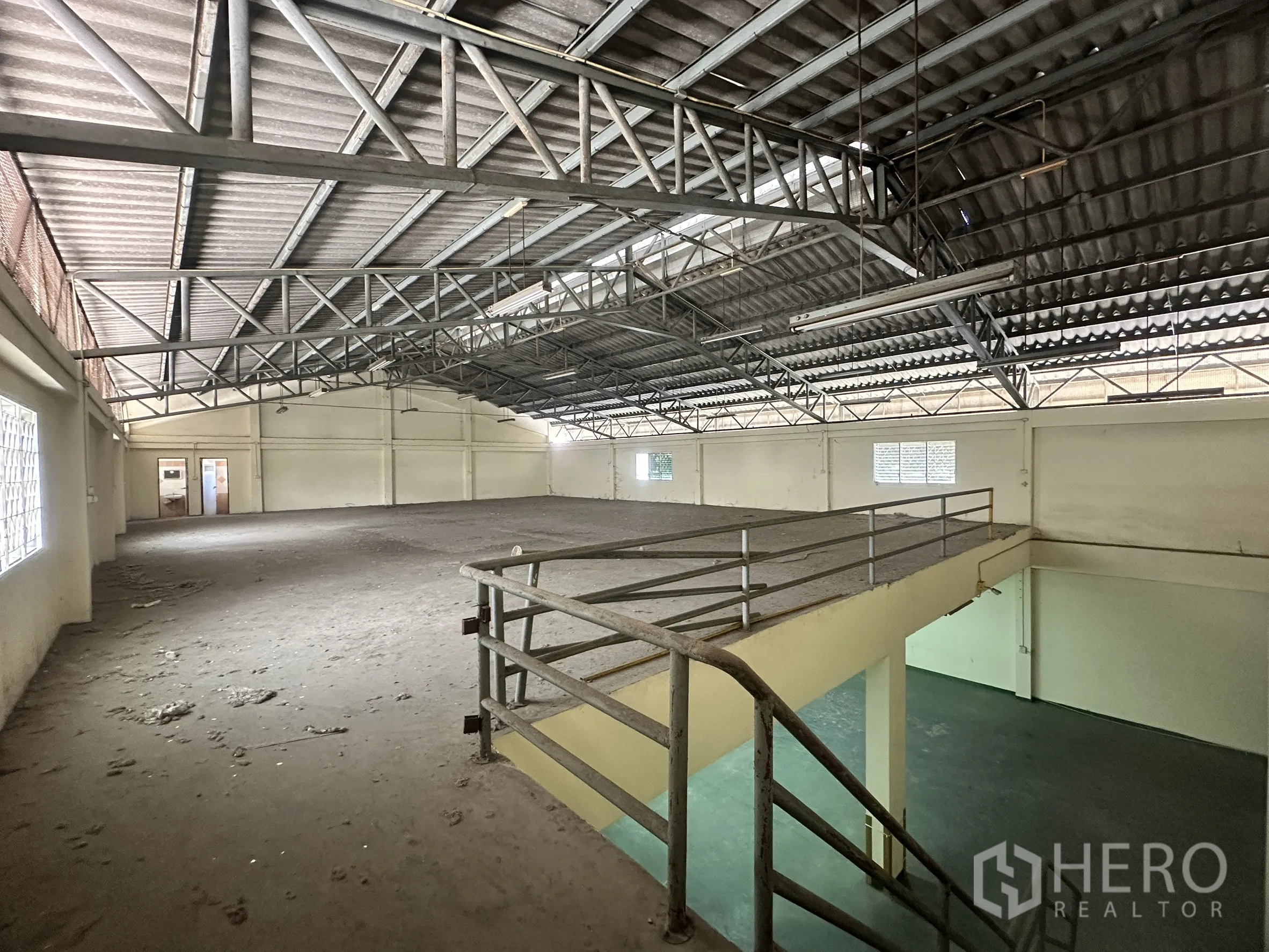 Factory for sale in Bang Bua Thong, Nonthaburi - Elevated mezzanine loft providing extra storage beneath a steel roof.