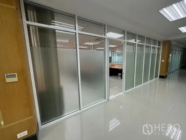 Office Space for rent in Suan Luang, Bangkok - Corridor with frosted glass partitioned offices, polished tile floor and bright ceiling lights in a Suan Luang, Bangkok office.