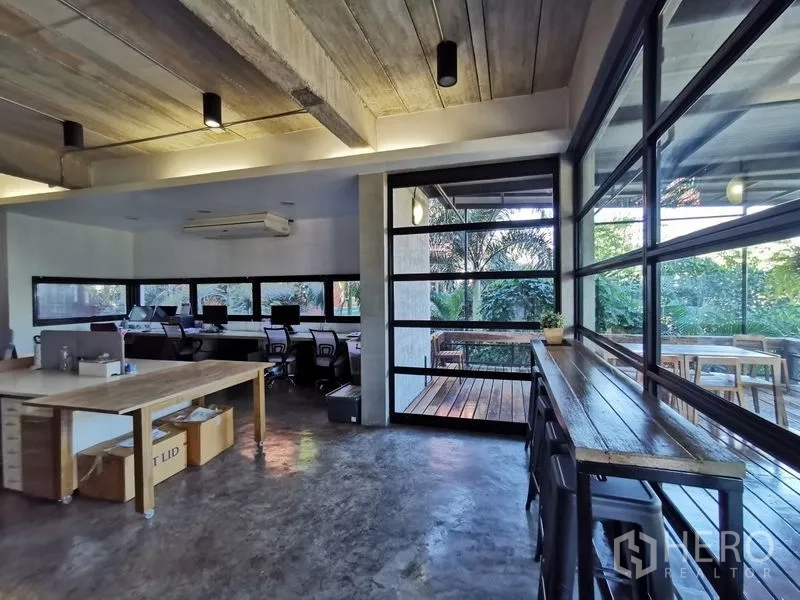 Home Office for sale in Wang Thonglang, Bangkok - Open-plan workspace with desks, large windows and access to a covered deck.