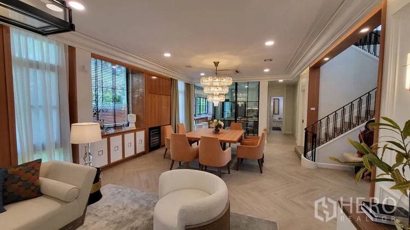 Detached House for rent or sale in Saphan Sung, Bangkok - Open-plan living and dining area with statement chandelier and six-seat dining table.