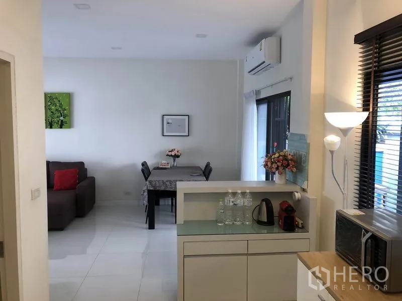 Townhouse for rent in Saphan Sung, Bangkok - View from kitchen to lounge and dining zone with white tiled floors and natural light