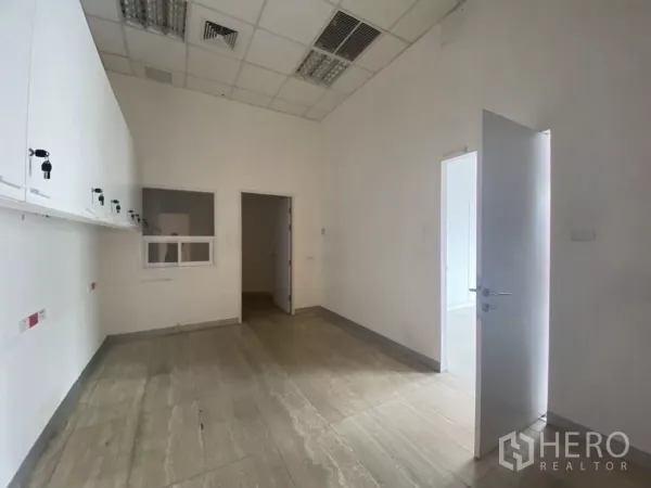 Retail Space for rent in Bang Rak, Bangkok - Back-of-house room featuring built-in white cabinets, grid ceiling and internal doorways.