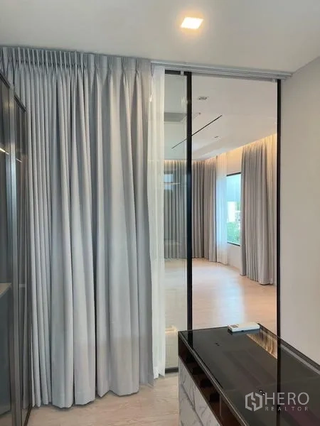 Detached House for rent or sale in Saphan Sung, Bangkok - Master suite entrance with glass partition and drapes connecting to the dressing area.