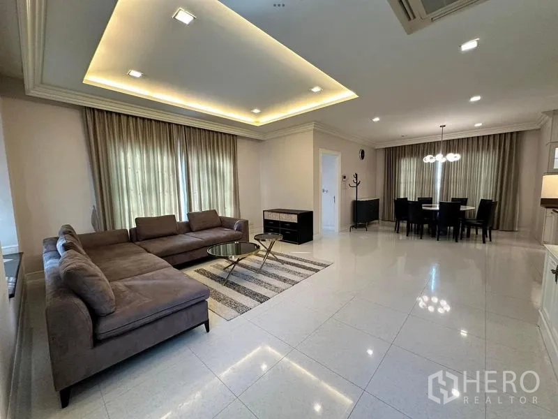 Detached House for rent or sale - Open-plan living and dining room with recessed ceiling lights and large curtained windows.