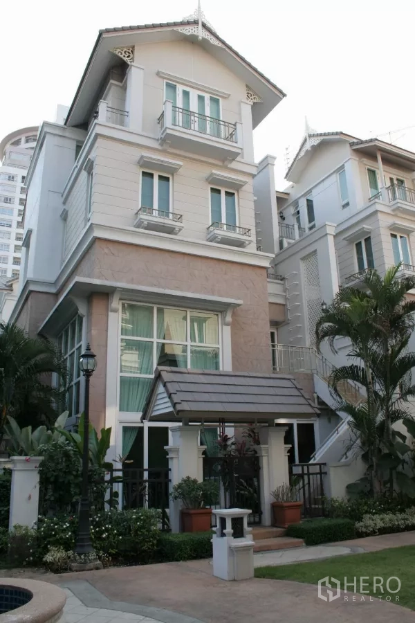 Townhouse for rent in Bang Kho Laem, Bangkok - English-style townhouse facade with tall windows and a small porch in a gated estate