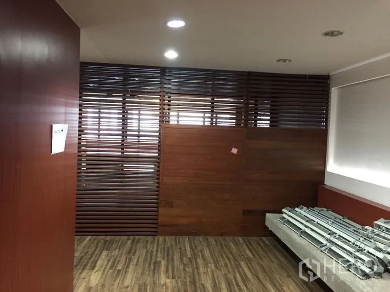 Office Space for sale in Watthana, Bangkok - Reception or breakout zone with slatted wood partition and recessed lighting.